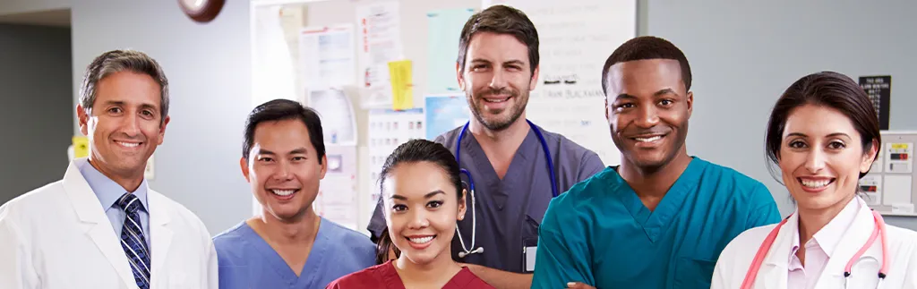 Healthcare workers at an international nurse staffing agency posing for a group photo